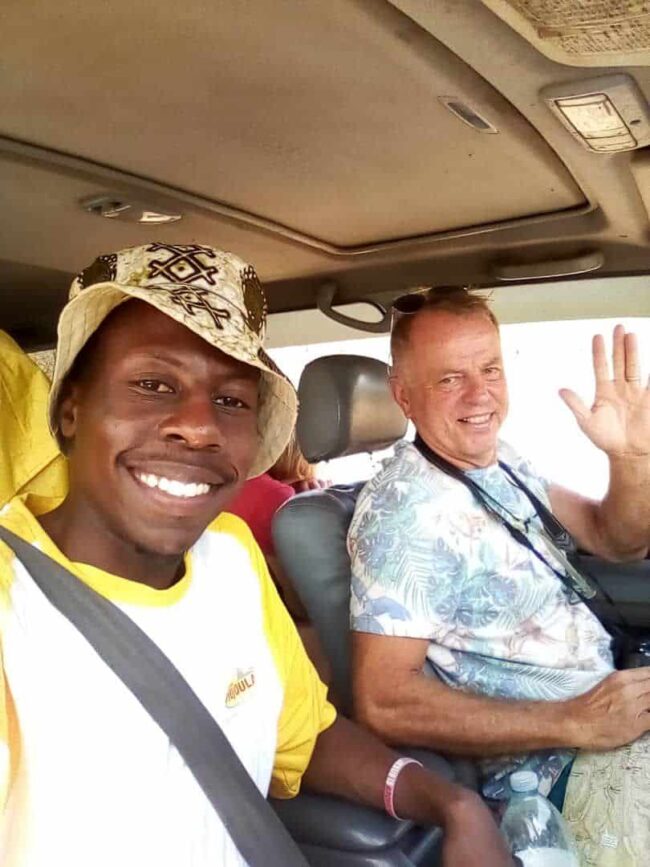 Traveler with local driver during a chauffeur-driven car rental experience in East Africa