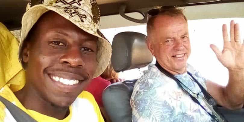 Traveler with local driver during a chauffeur-driven car rental experience in East Africa