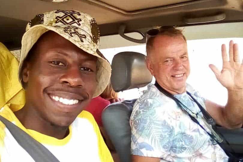 Traveler with local driver during a chauffeur-driven car rental experience in East Africa