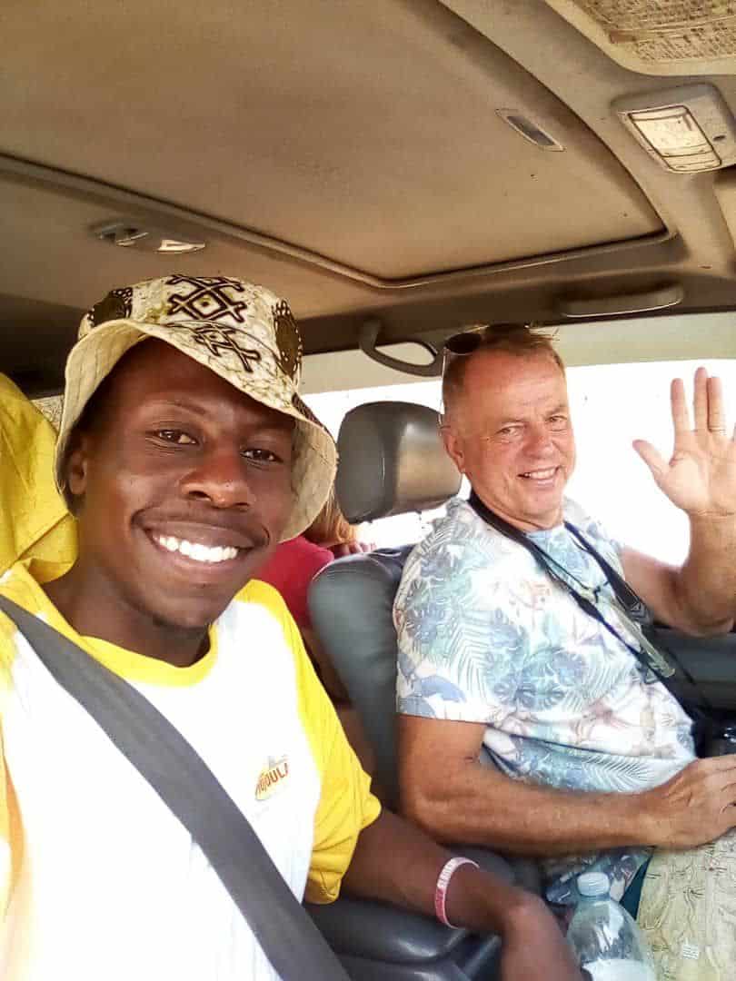Traveler with local driver during a chauffeur-driven car rental experience in East Africa