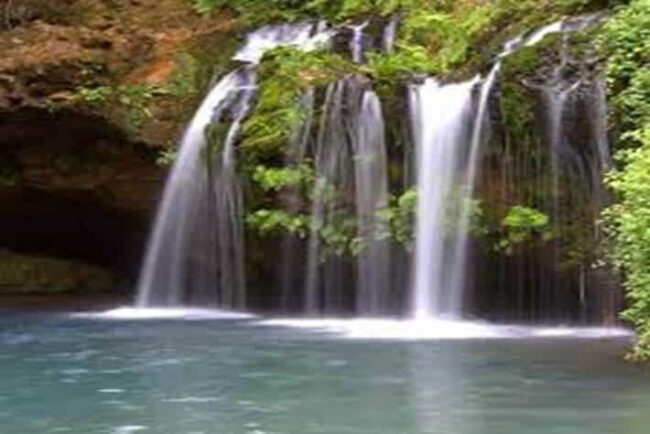 Scenic waterfalls in Mount Elgon National Park, Kenya surrounded by lush greenery